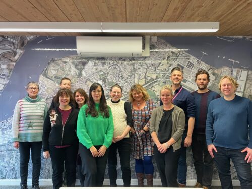 10 people standing in front of a map of Thamesmead to launch Bexley Culture Network