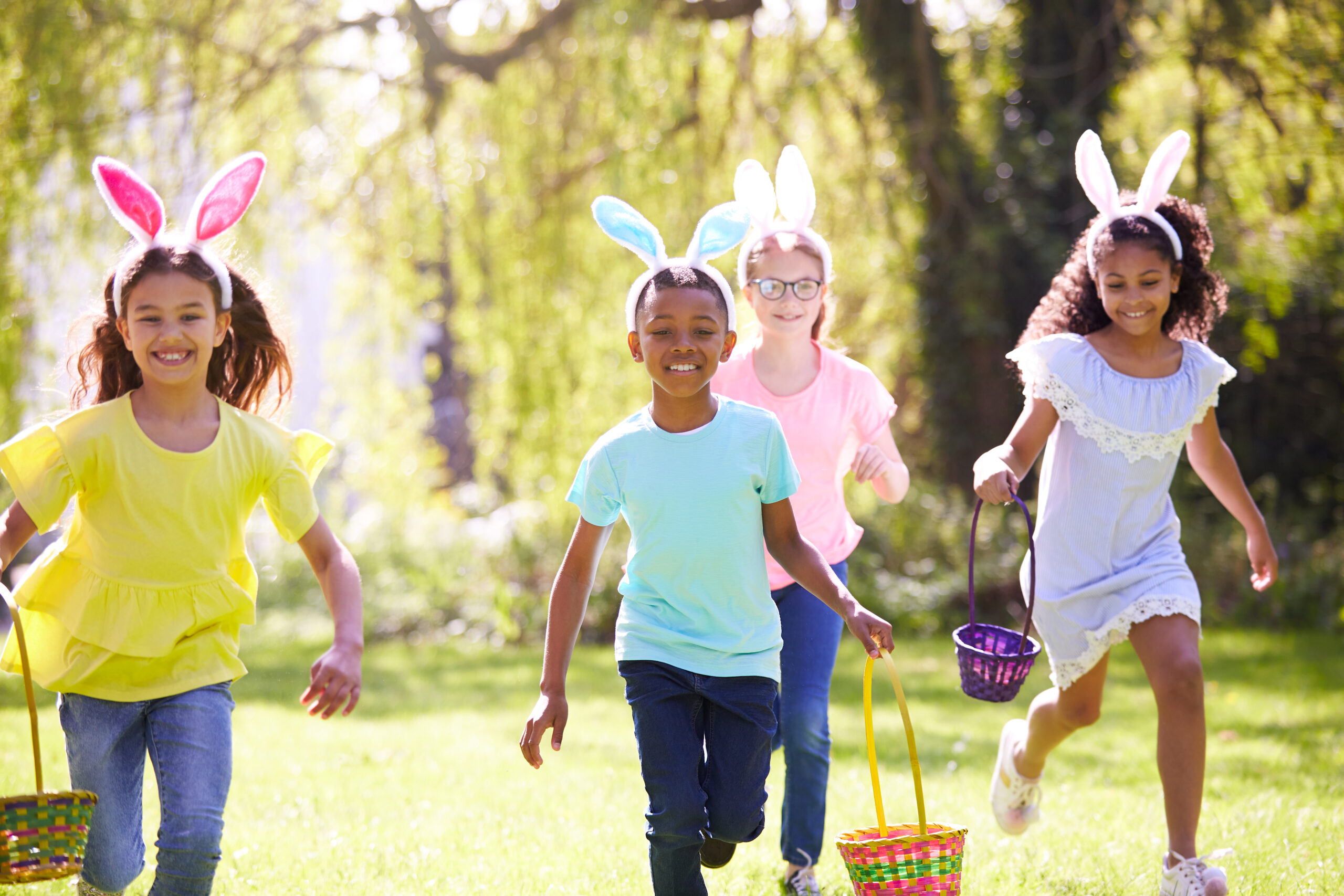 three children wearing rabbit ears who are on an Easter Egg Hunt