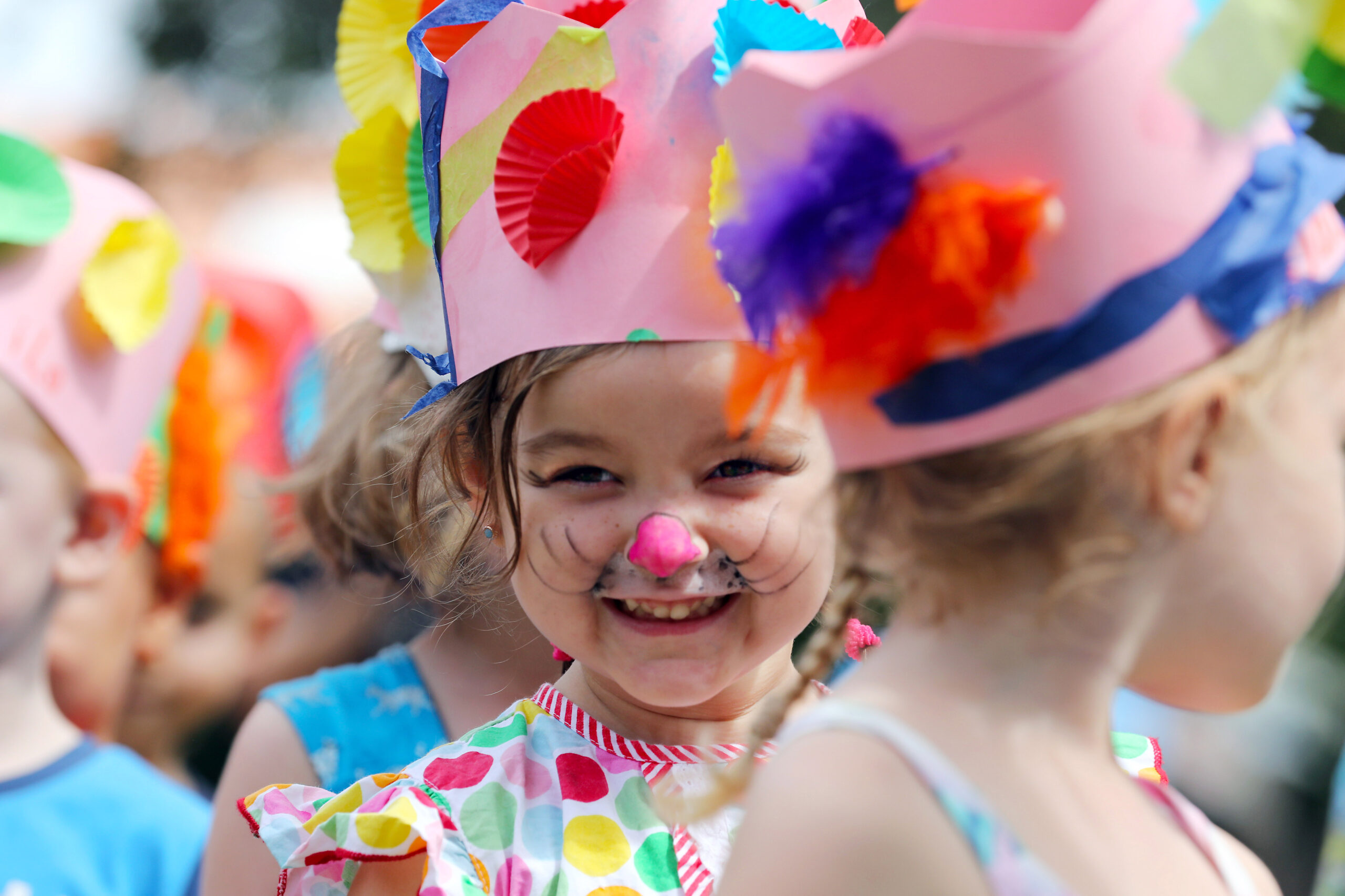 Smiling girl wearing a pink Easter bonnet