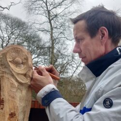 Man carving a wooden owl