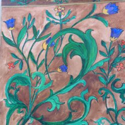 Green foliage pattern of intertwined leaves with blue flowers