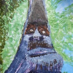 Image of an old man carved into the side of a tree