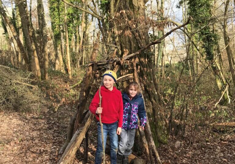 Children in their den in the woods