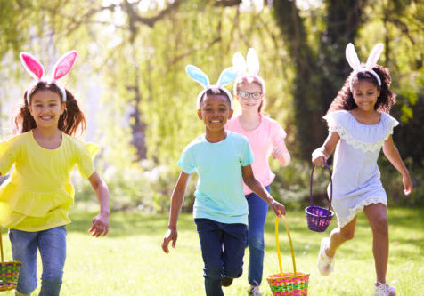 three children wearing rabbit ears who are on an Easter Egg Hunt