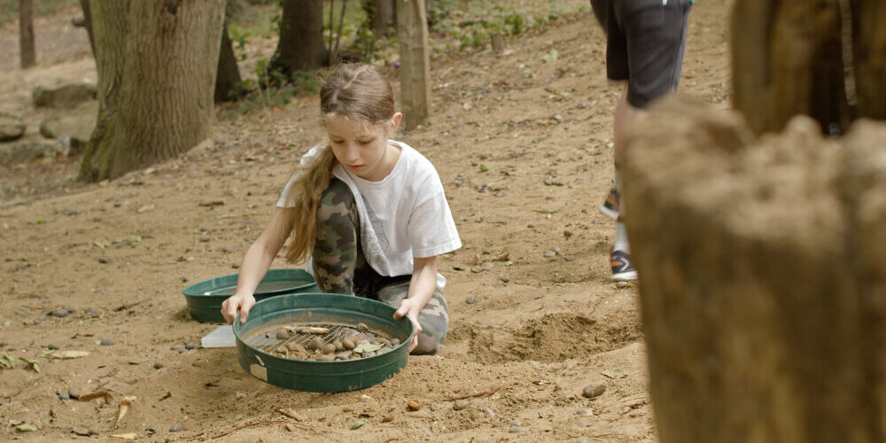 Girl sieving for fossils