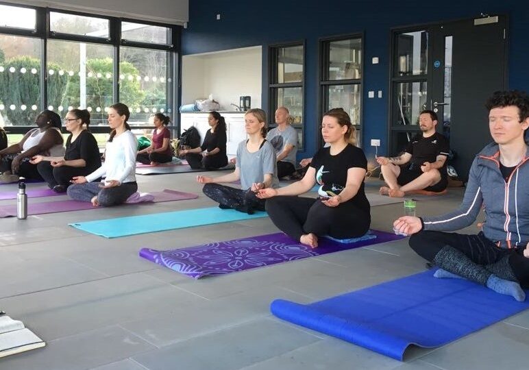 Yoga class sitting in lotus position